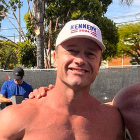 Amuscular men posing outdoors with a clear sky and trees in the background signifying slowing down aging, regrowing hair with topical solution, increasing and elevating testosterone with eating healthy foods, edging, and getting test cyp over the counter.