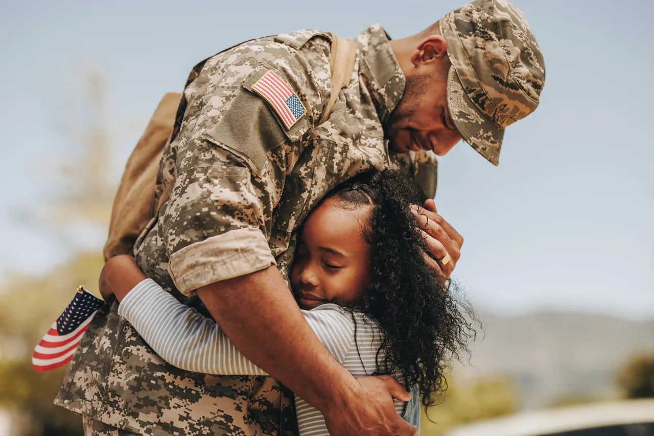 Veteran father hugging young daughter in uniform, symbolizing renewed vitality, emotional balance, and post-service testosterone replacement therapy. Ideal for users searching “buy TRT online for veterans,” “testosterone therapy for military men over 40,” “online testosterone replacement consultation.”