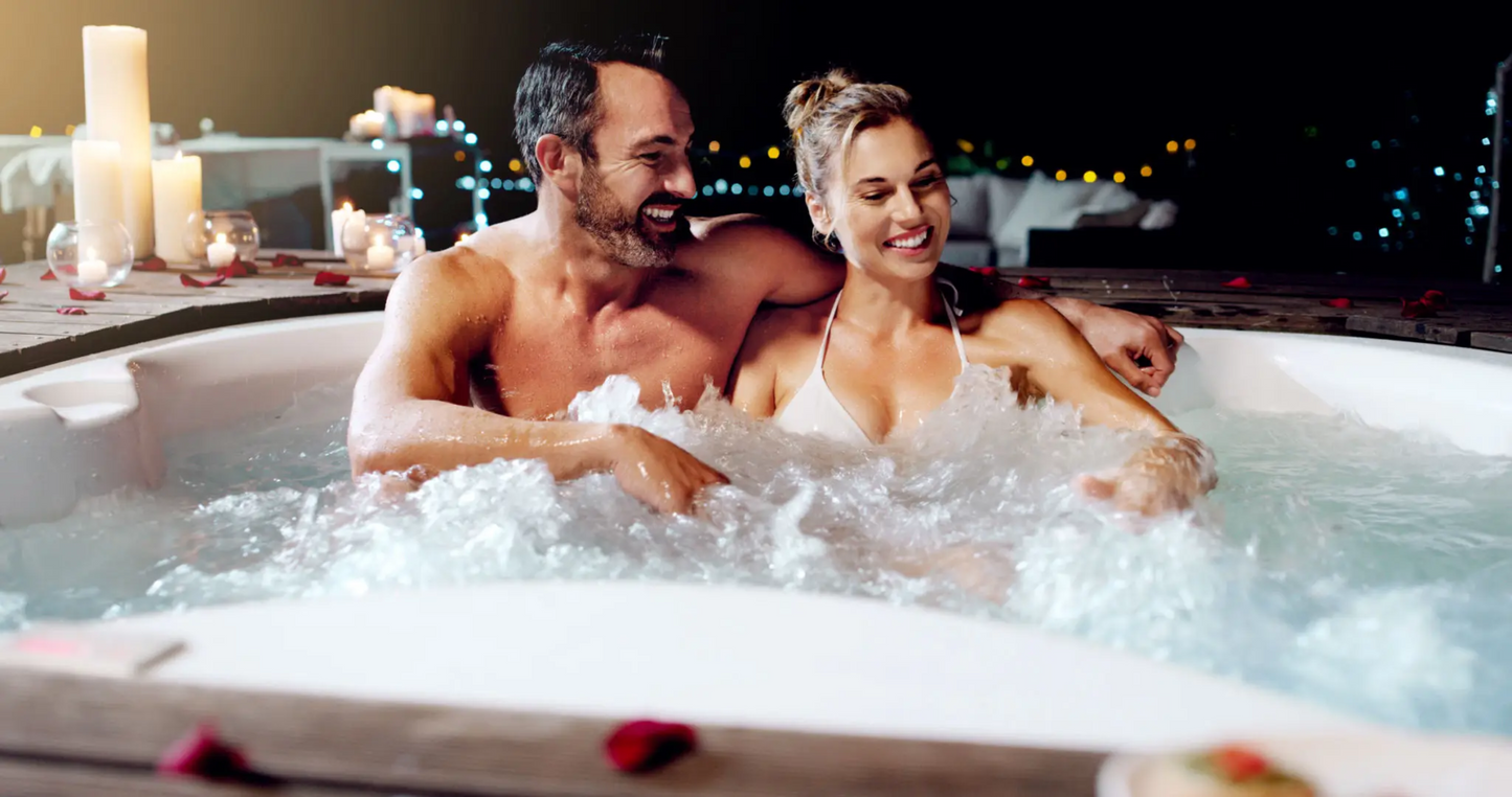 A confident, smiling middle-aged couple relaxing in a romantic hot tub setting at night, symbolizing the restored intimacy, satisfaction, and connection that comes with using Full Throttle — a physician-prescribed tadalafil-based treatment for erectile dysfunction and performance enhancement in men over 40.